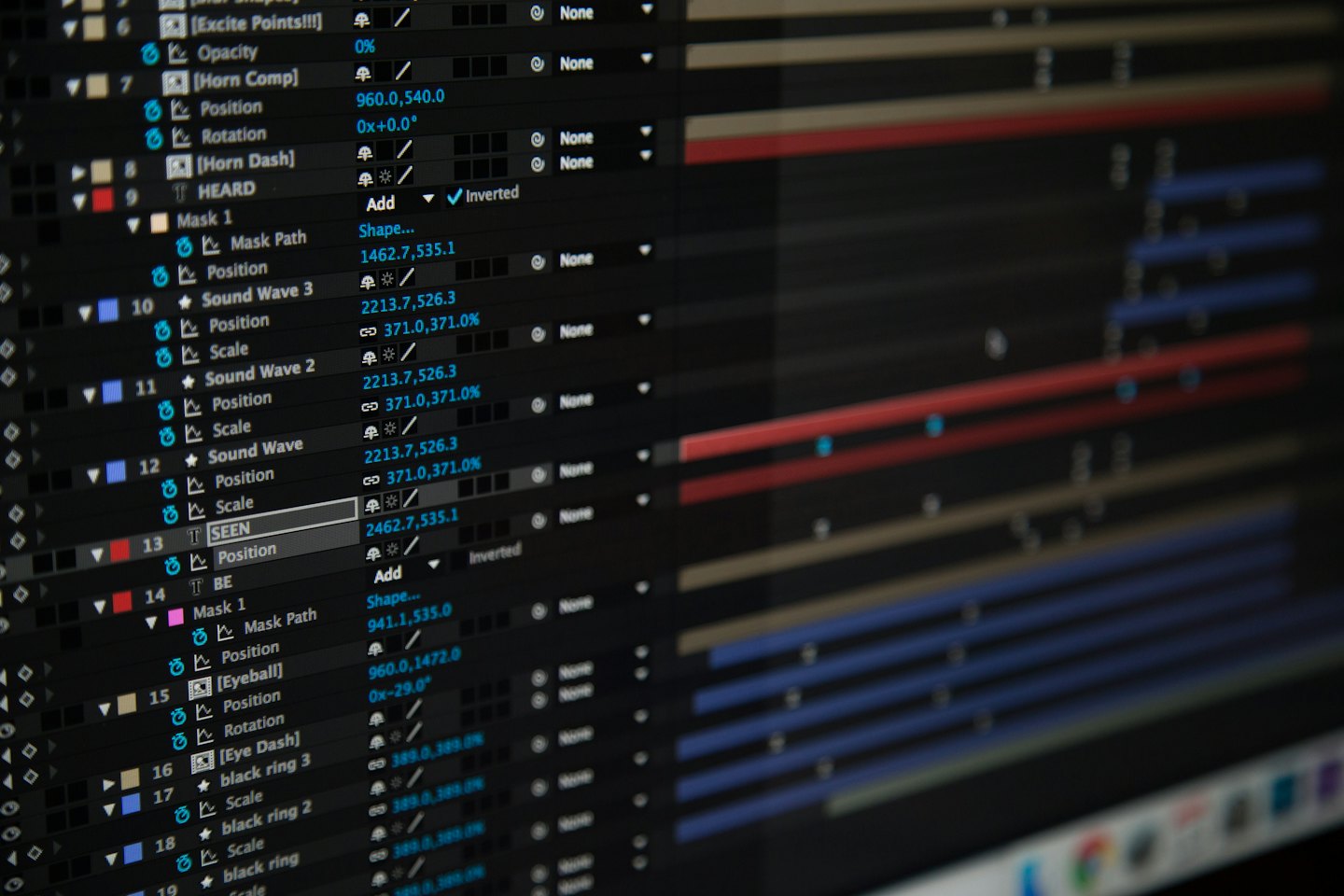 Computer screen displays complex video editing software interface with code and timelines.